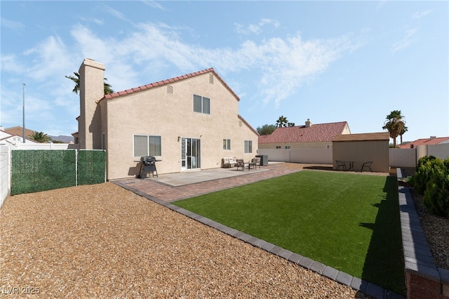 rear view of house featuring stucco siding, central air condition unit, a lawn, a patio, and a fenced backyard