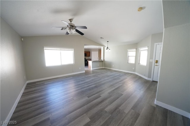 unfurnished living room featuring baseboards, lofted ceiling, dark wood finished floors, and a ceiling fan