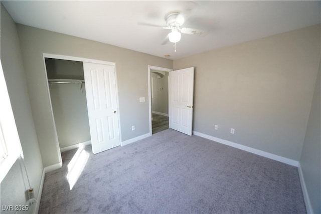 unfurnished bedroom with a ceiling fan, baseboards, a closet, and carpet floors