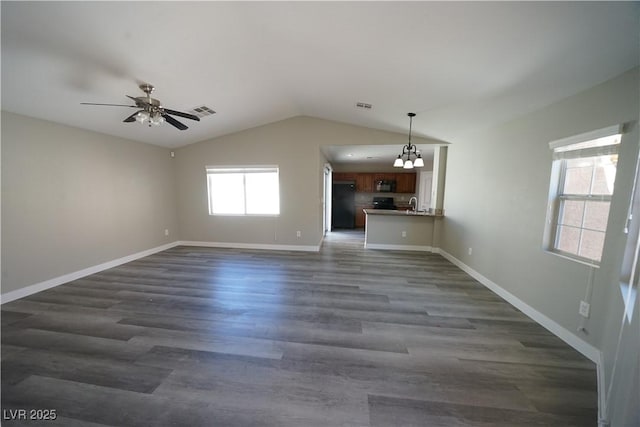 unfurnished living room featuring lofted ceiling, dark wood-style floors, and visible vents