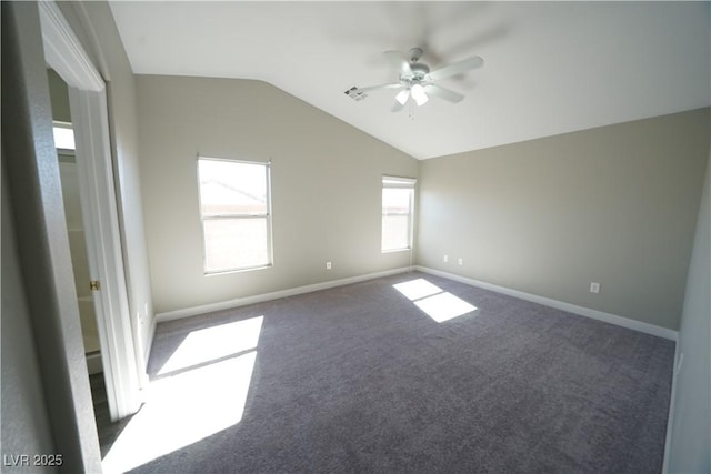 carpeted spare room with baseboards, lofted ceiling, visible vents, and ceiling fan