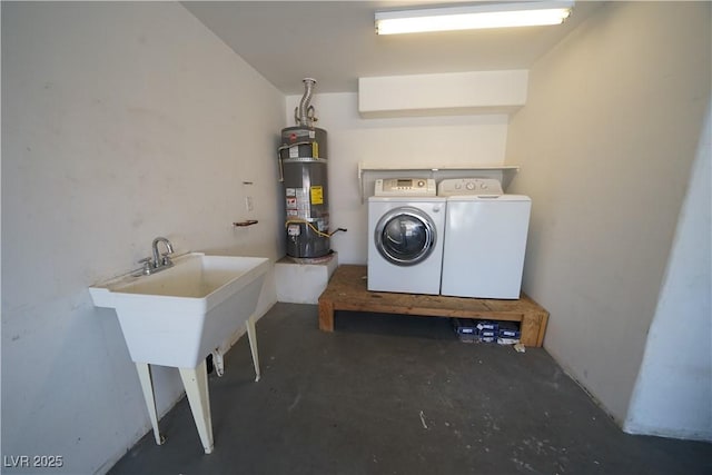 laundry area featuring strapped water heater, laundry area, and washing machine and clothes dryer