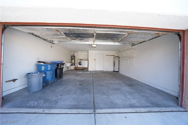 garage with water heater and independent washer and dryer