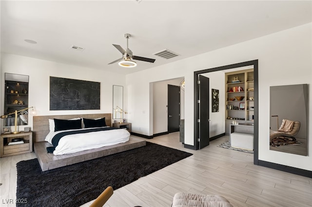 bedroom with light wood-style flooring, baseboards, visible vents, and ceiling fan