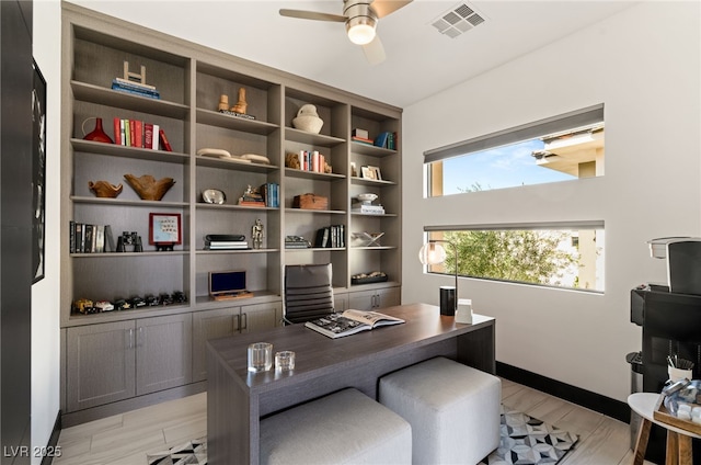 office featuring visible vents, ceiling fan, baseboards, and light wood-style floors