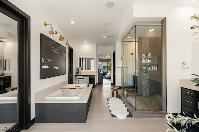 bathroom featuring visible vents, a garden tub, a stall shower, recessed lighting, and vanity