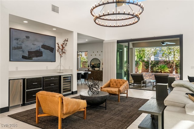 living room featuring a high ceiling, wine cooler, and visible vents