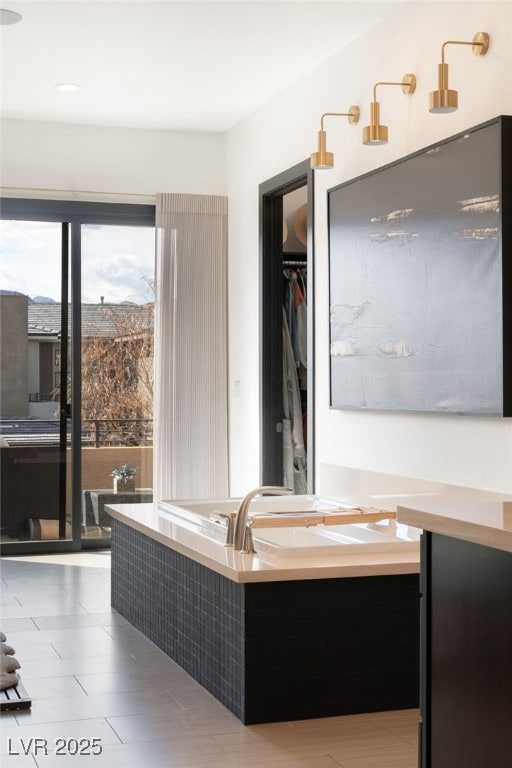 bathroom featuring a spacious closet and vanity