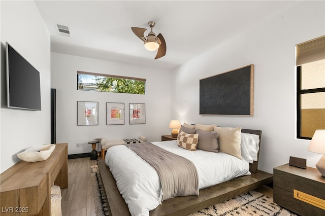 bedroom featuring visible vents, light wood-type flooring, and a ceiling fan