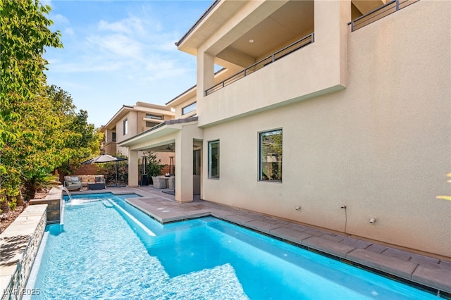 view of swimming pool featuring a patio area, an outdoor living space, fence, and a fenced in pool