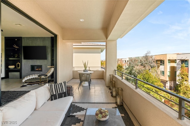 balcony with visible vents and outdoor lounge area