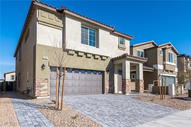 view of front of house featuring stucco siding, stone siding, and an attached garage