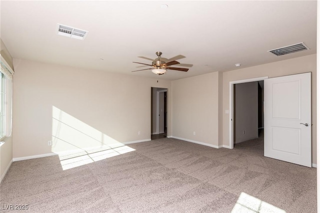 spare room featuring visible vents, ceiling fan, baseboards, and carpet