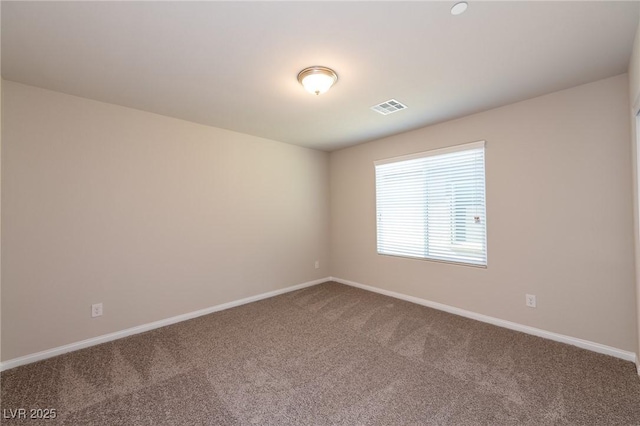 empty room featuring visible vents, baseboards, and carpet flooring