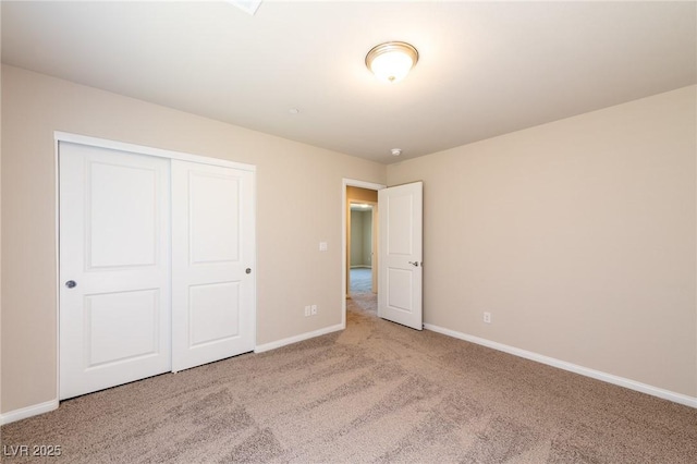 unfurnished bedroom featuring a closet, baseboards, and carpet floors