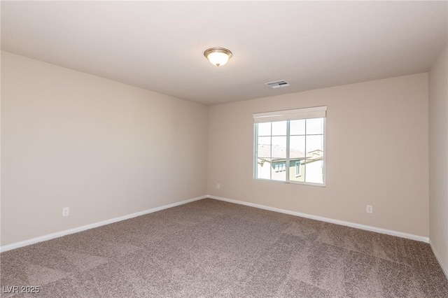 unfurnished room with carpet, visible vents, and baseboards