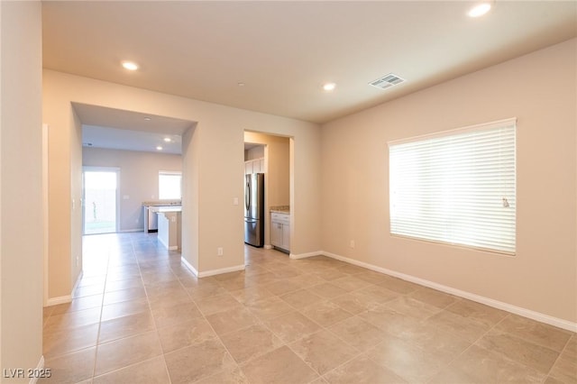 unfurnished room with light tile patterned flooring, visible vents, recessed lighting, and baseboards