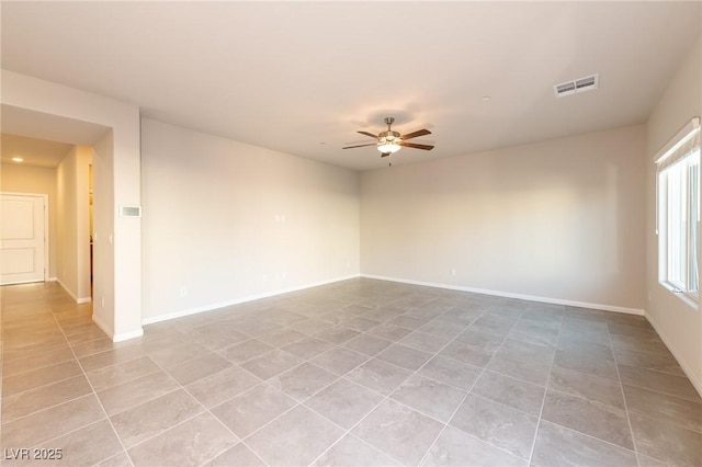 unfurnished room with light tile patterned flooring, a ceiling fan, visible vents, and baseboards