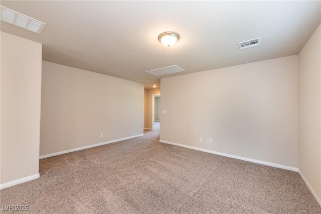 carpeted empty room featuring baseboards and visible vents