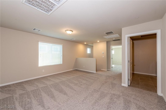 tiled empty room featuring carpet flooring, recessed lighting, baseboards, and visible vents