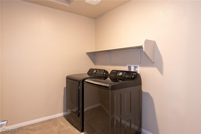 laundry room with light tile patterned floors, baseboards, independent washer and dryer, and laundry area