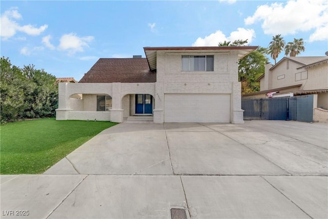 view of front of home with stucco siding, driveway, an attached garage, and a front yard