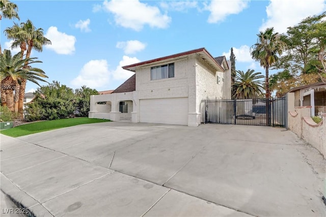 view of side of property featuring a garage, concrete driveway, and stucco siding