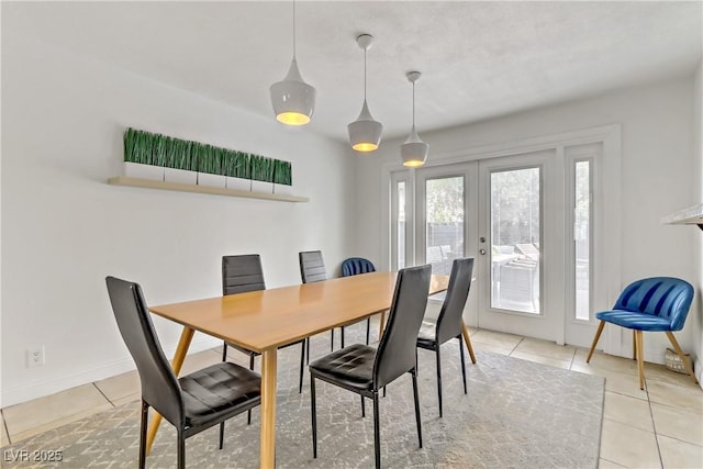 dining room featuring light tile patterned floors, french doors, and baseboards