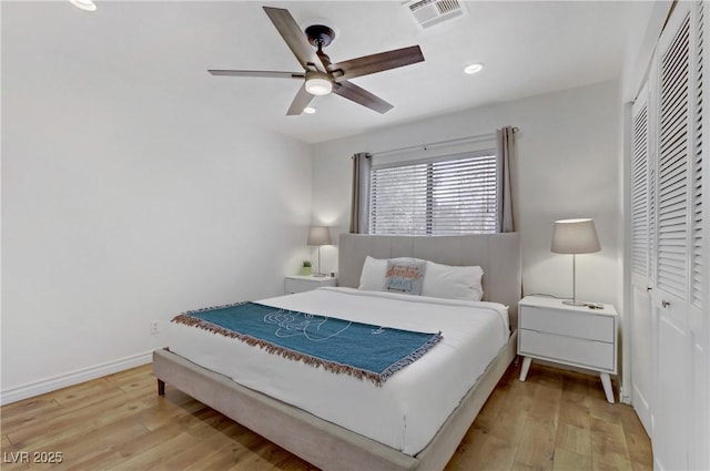 bedroom featuring a closet, visible vents, light wood finished floors, and baseboards