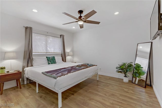 bedroom with recessed lighting, light wood-type flooring, and baseboards