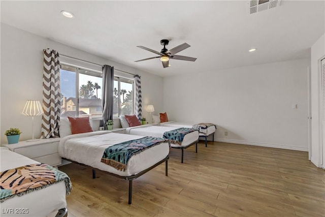 bedroom with recessed lighting, visible vents, light wood-style flooring, and baseboards