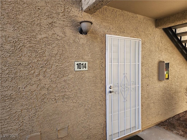 doorway to property with stucco siding