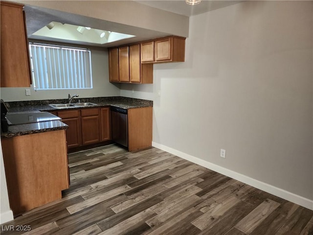 kitchen with dark wood-type flooring, baseboards, brown cabinets, stainless steel dishwasher, and a sink