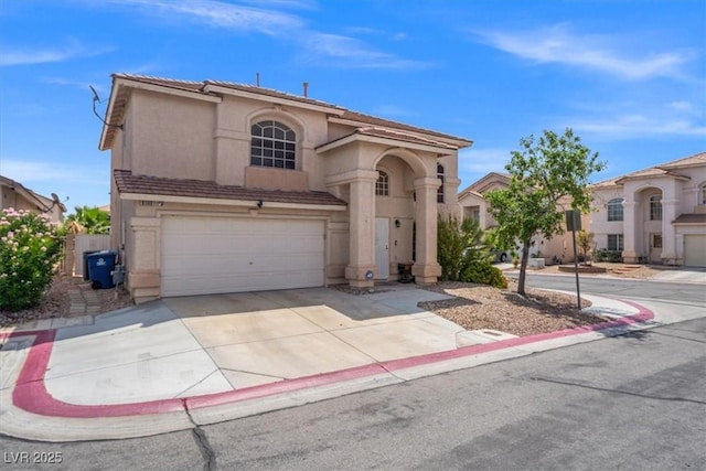 mediterranean / spanish-style house with stucco siding, driveway, and an attached garage