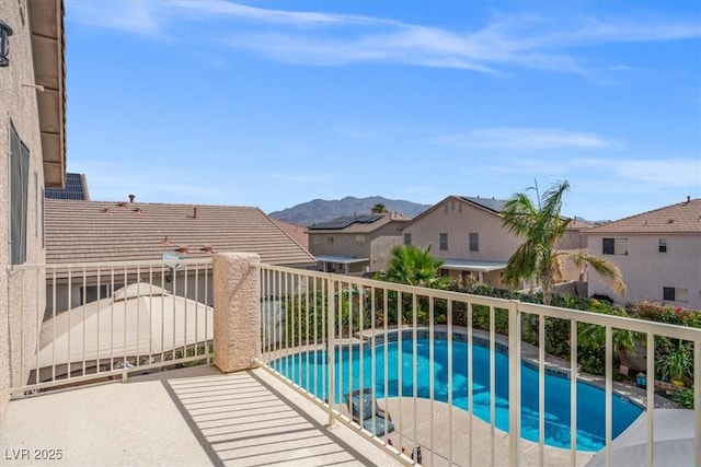 view of swimming pool with a mountain view and a fenced in pool