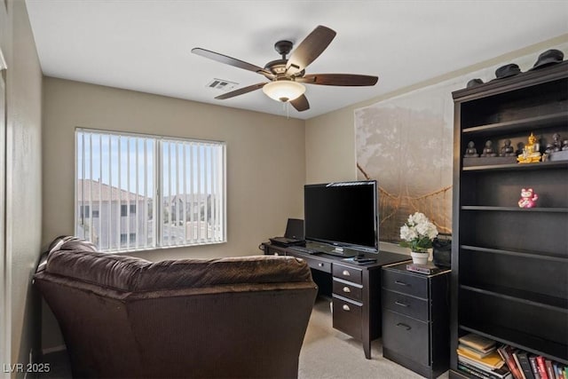 living room with a ceiling fan, visible vents, and light carpet