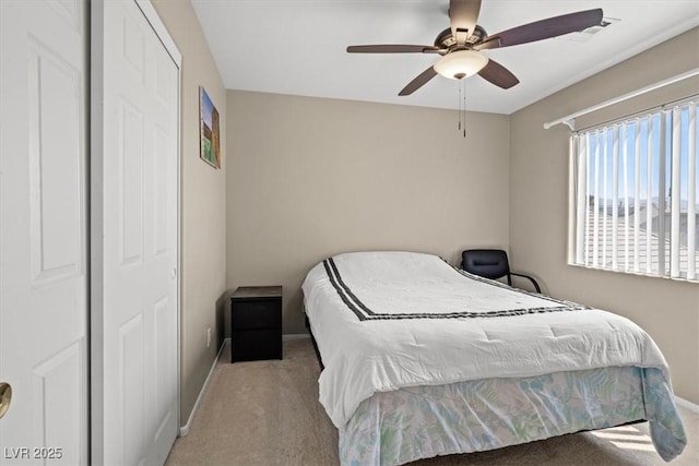 bedroom featuring visible vents, a ceiling fan, baseboards, and light carpet