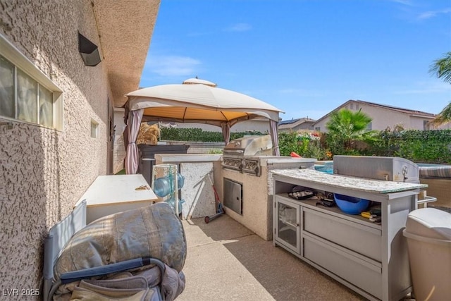 view of patio featuring a gazebo, area for grilling, and grilling area