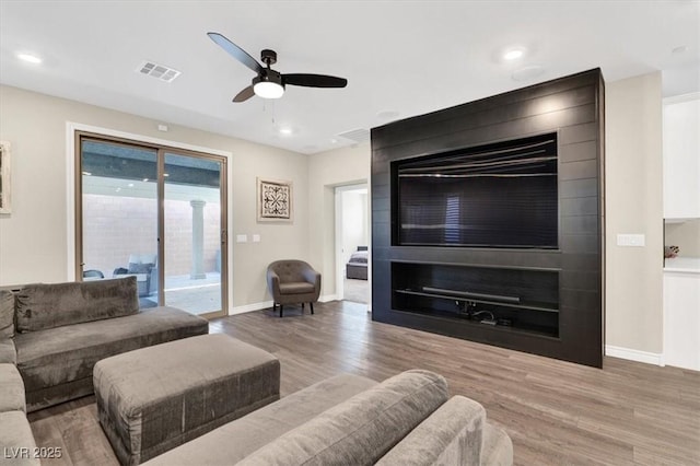 living room with visible vents, a ceiling fan, wood finished floors, recessed lighting, and baseboards