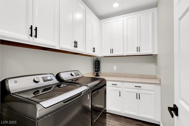 washroom featuring cabinet space, independent washer and dryer, and wood finished floors