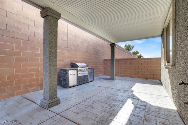 view of patio / terrace with area for grilling and fence