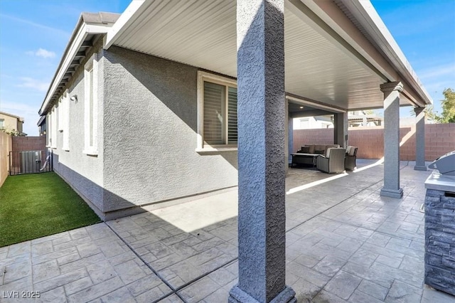 view of patio featuring an outdoor hangout area and a fenced backyard