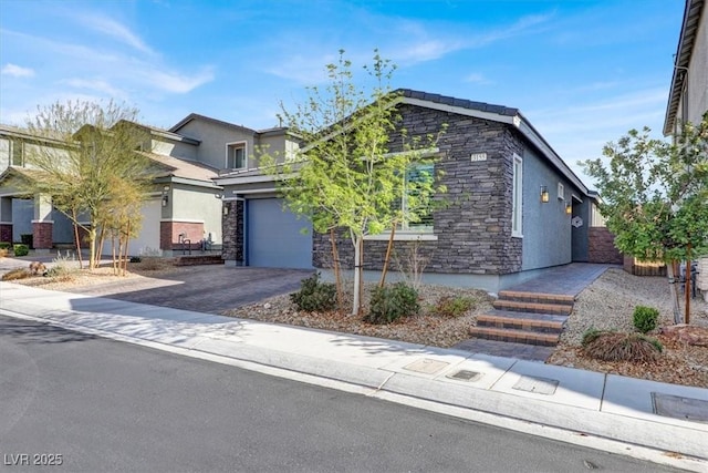 view of front of home featuring stucco siding, stone siding, a garage, and driveway