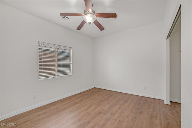 unfurnished bedroom featuring ceiling fan, light wood-style floors, visible vents, and baseboards