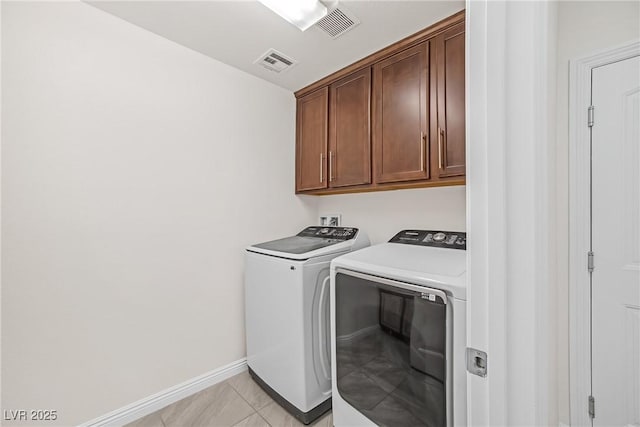 laundry room with cabinet space, visible vents, washing machine and dryer, and baseboards