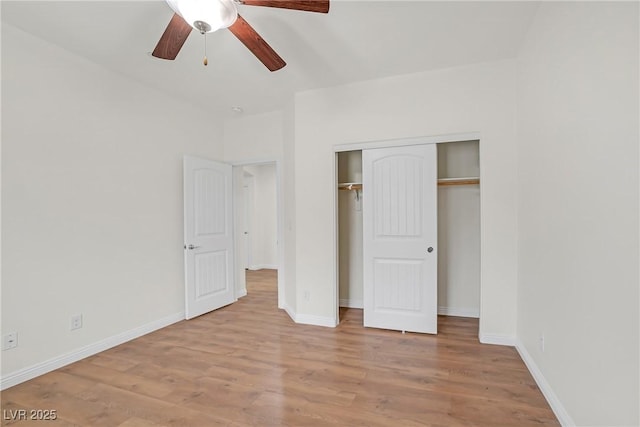 unfurnished bedroom with a closet, baseboards, and wood finished floors