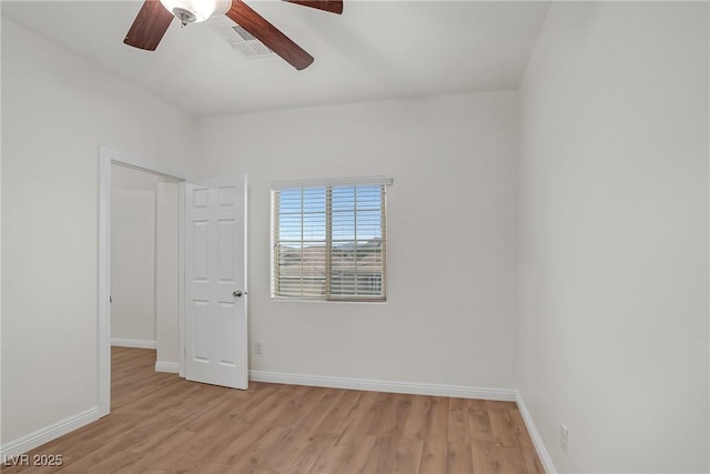 unfurnished room with a ceiling fan, baseboards, visible vents, and light wood-type flooring