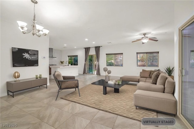 living room with recessed lighting and ceiling fan with notable chandelier