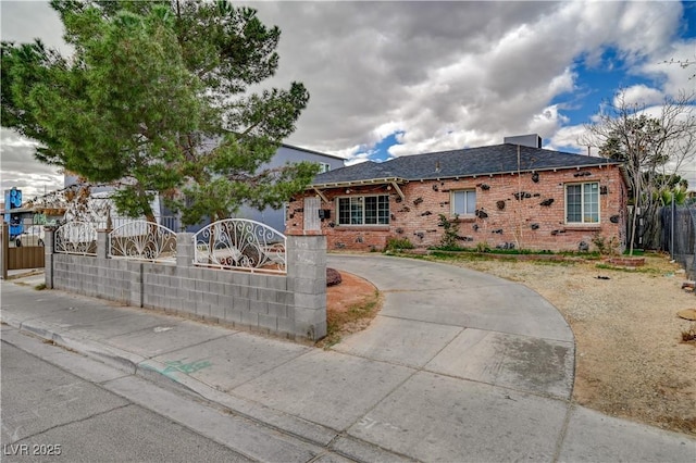 single story home featuring brick siding, fence private yard, and concrete driveway