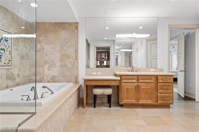 full bathroom featuring recessed lighting, a jetted tub, and vanity